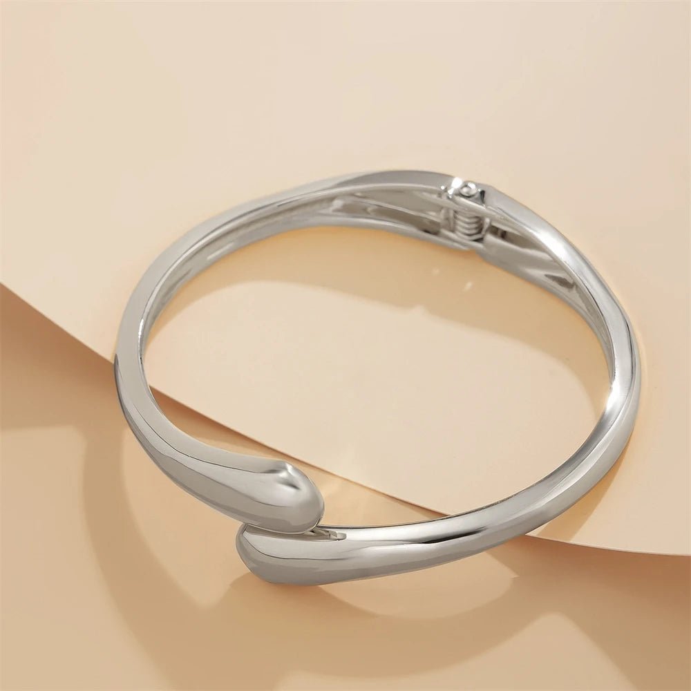 Wide metal bracelet with elegant twisted design